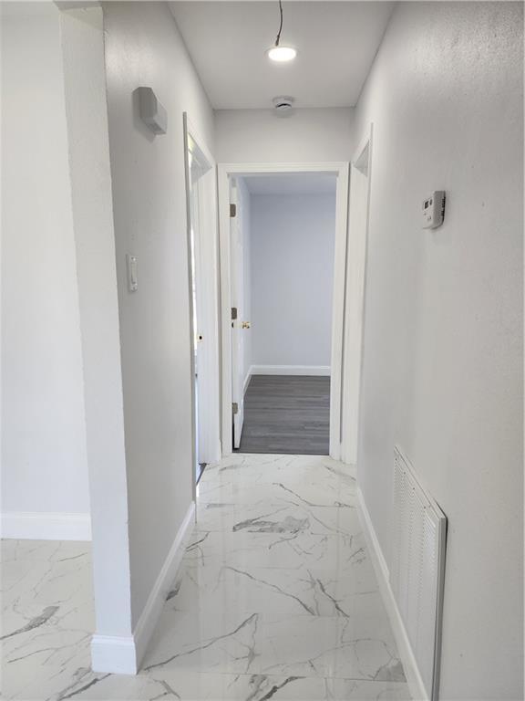 2405 Tattersall Dr, Harvey, LA 70058 - corridor with marble finish floor, baseboards, and visible vents
