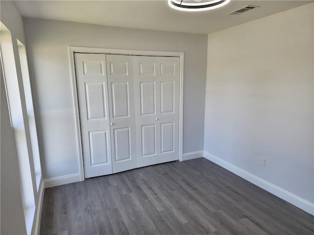2405 Tattersall Dr, Harvey, LA 70058 - unfurnished bedroom featuring visible vents, baseboards, a closet, and dark wood finished floors