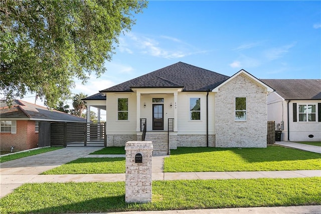 400 Mink Dr, Arabi, LA 70032 - view of front of property featuring a front yard and a shingled roof