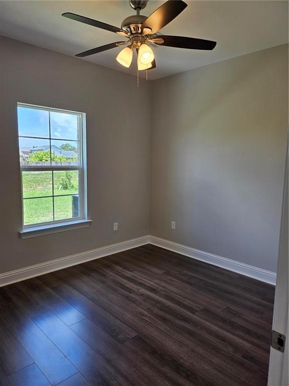 719 Rue St, Michael, Terrytown, LA 70056 - unfurnished room with dark wood-style floors and ceiling fan