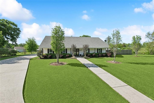 313 Sarah Victoria Dr, Belle Chasse, LA 70037 - tudor-style house featuring a front yard and stucco siding