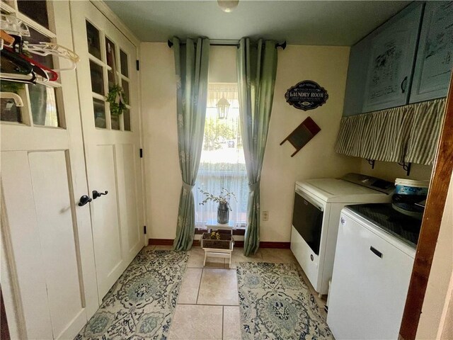 313 Sarah Victoria Dr, Belle Chasse, LA 70037 - laundry area with cabinet space, light tile patterned floors, baseboards, and washing machine and dryer