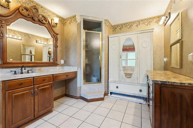 313 Sarah Victoria Dr, Belle Chasse, LA 70037 - full bath with baseboards, a textured ceiling, vanity, tile patterned floors, and a stall shower