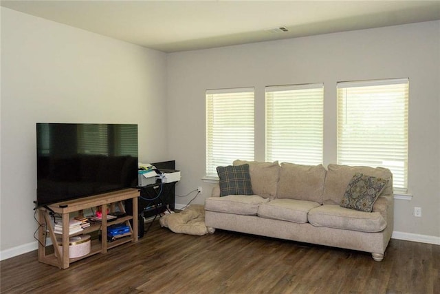 living area with wood finished floors and baseboards