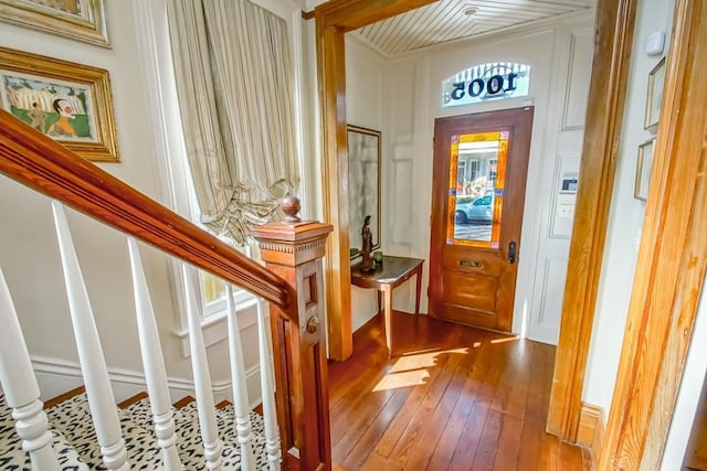 foyer entrance featuring hardwood / wood-style floors and stairway