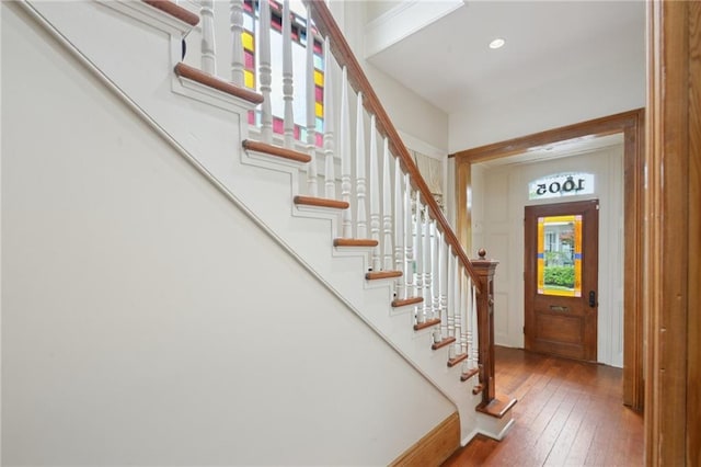 foyer entrance with stairway, hardwood / wood-style floors, and recessed lighting