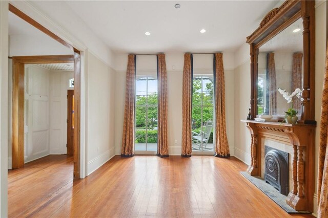 unfurnished living room with light wood-style floors, baseboards, and recessed lighting