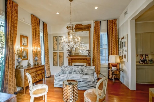 sitting room with wood finished floors, a chandelier, and recessed lighting