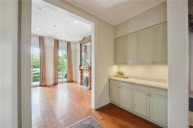 bar featuring hardwood / wood-style floors, baseboards, and recessed lighting