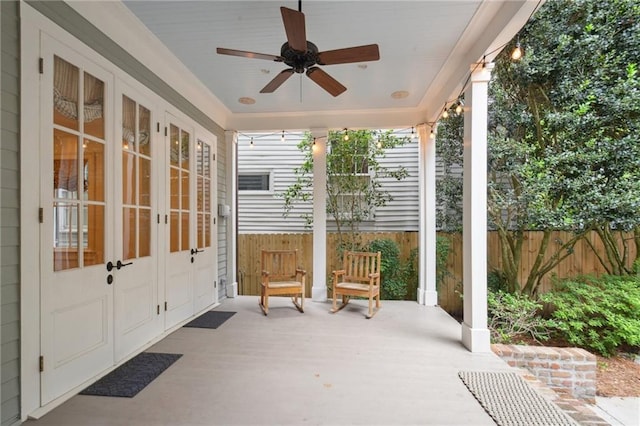 view of patio with french doors, fence, and ceiling fan