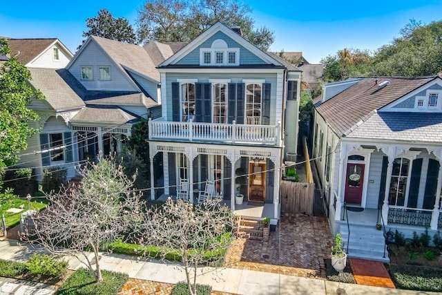 victorian house with covered porch and a balcony