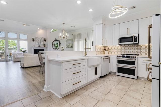 1612 Marina Dr, Slidell, LA 70458 - kitchen featuring crown molding, white appliances, a chandelier, a sink, and open floor plan