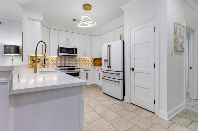 1612 Marina Dr, Slidell, LA 70458 - kitchen featuring a sink, light countertops, white appliances, white cabinetry, and decorative backsplash