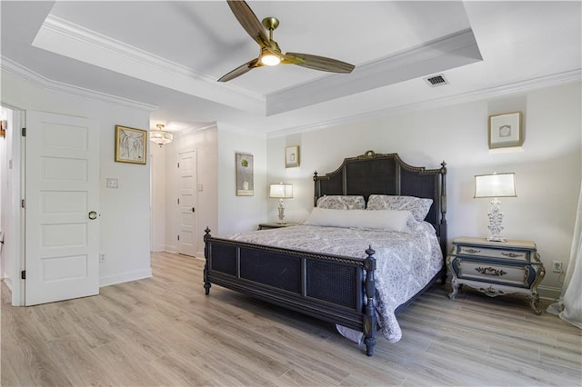 1612 Marina Dr, Slidell, LA 70458 - bedroom featuring a tray ceiling, wood finished floors, ornamental molding, and visible vents