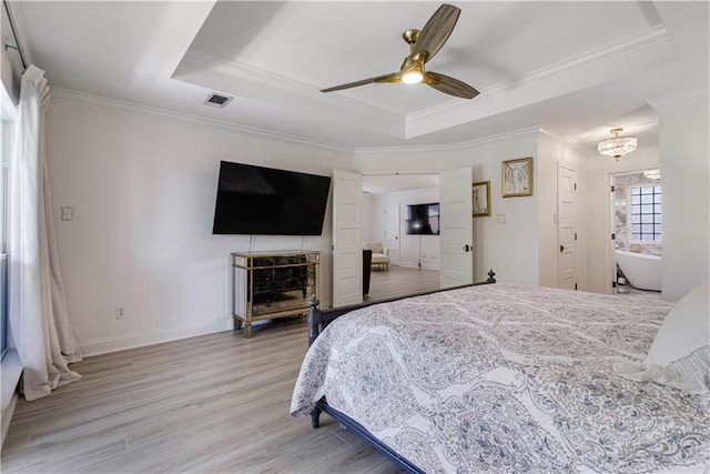 1612 Marina Dr, Slidell, LA 70458 - bedroom with crown molding, a tray ceiling, baseboards, and light wood-type flooring