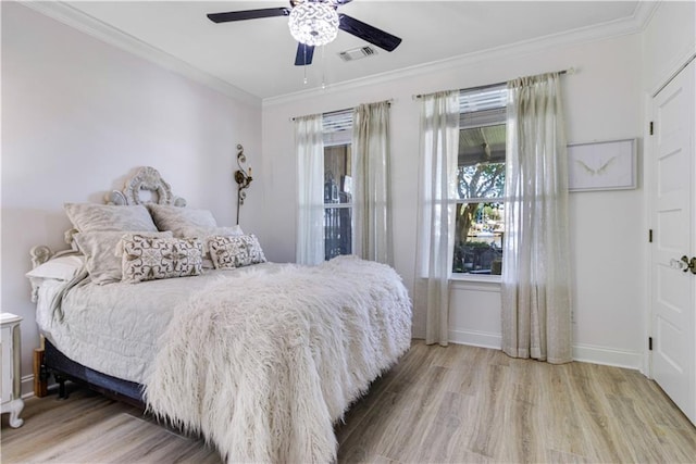 1612 Marina Dr, Slidell, LA 70458 - bedroom featuring baseboards, ornamental molding, visible vents, ceiling fan, and wood finished floors
