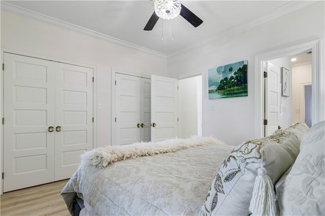 1612 Marina Dr, Slidell, LA 70458 - bedroom with light wood-style flooring, multiple closets, ornamental molding, and ceiling fan