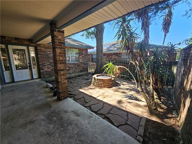 view of patio / terrace with an outdoor fire pit and fence