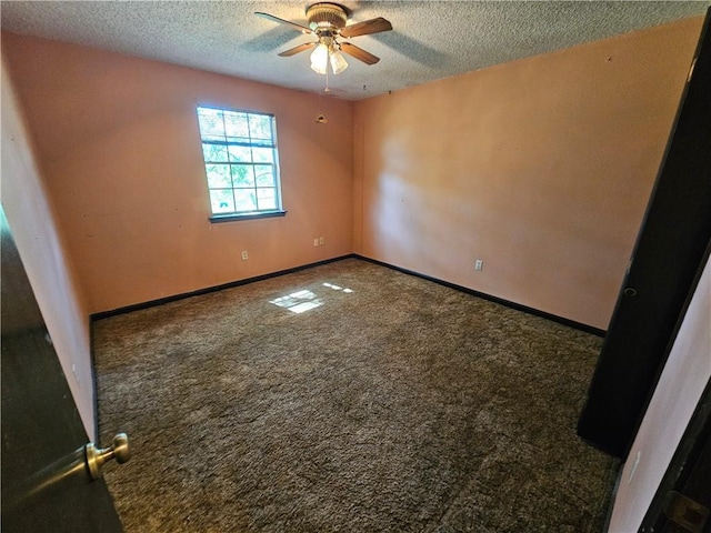 carpeted spare room featuring ceiling fan, baseboards, and a textured ceiling