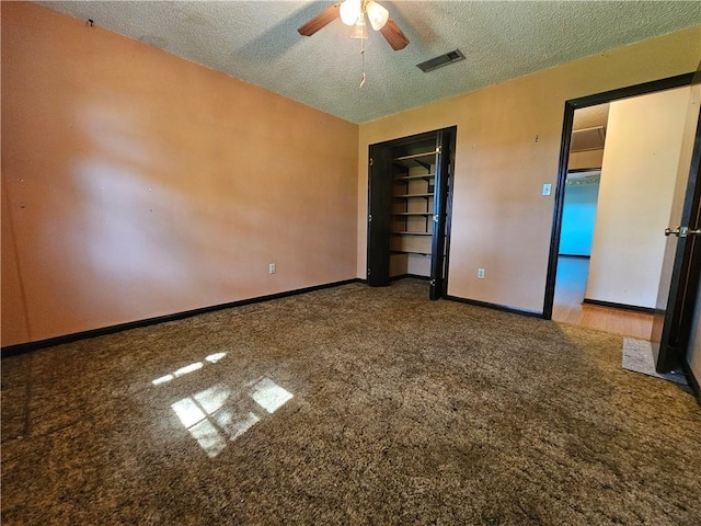 unfurnished bedroom with visible vents, a textured ceiling, and carpet floors