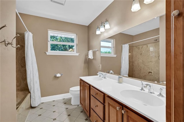 5245 Sanford St, Metairie, LA 70006 - full bathroom featuring toilet, baseboards, shower / bath combo, and double vanity