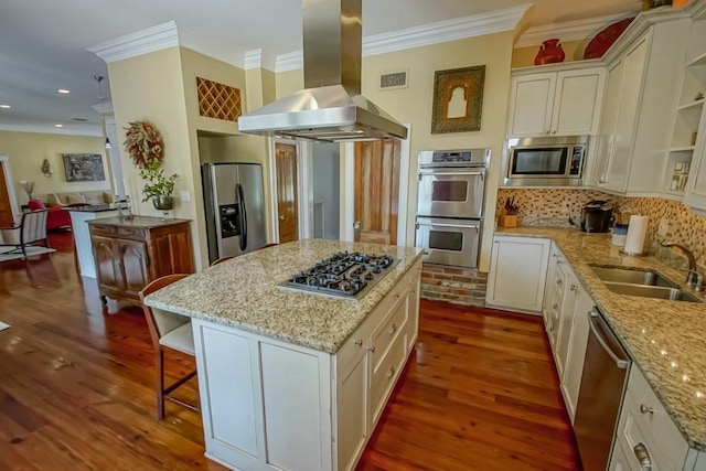 kitchen featuring a sink, stainless steel appliances, island exhaust hood, visible vents, and crown molding