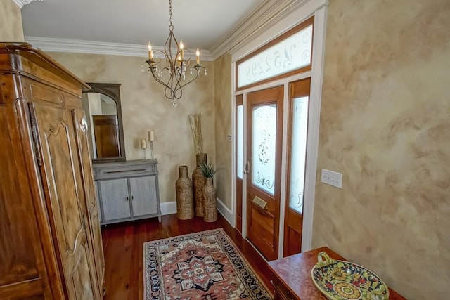 foyer with dark wood finished floors, a chandelier, baseboards, and ornamental molding