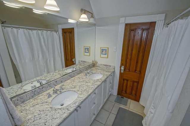 bathroom featuring double vanity, tile patterned flooring, and a sink