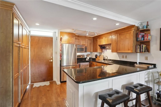 3915 St Charles Ave Unit 215, New Orleans, LA 70118 - kitchen featuring stainless steel appliances, a peninsula, open shelves, light wood-type flooring, and brown cabinets