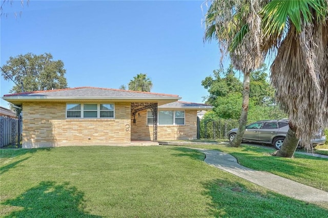 view of front of house featuring brick siding and a front lawn