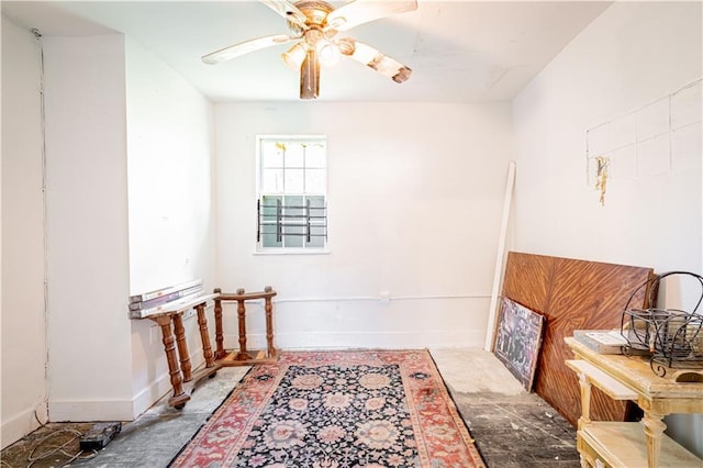 interior space featuring ceiling fan and baseboards