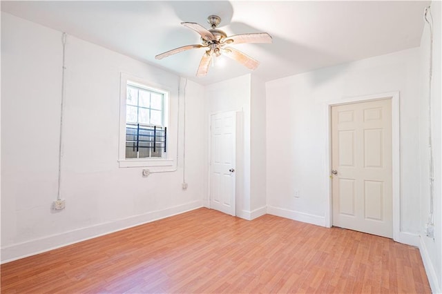 unfurnished room with baseboards, ceiling fan, and light wood-style flooring