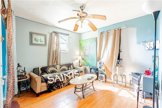 living room with a ceiling fan and wood finished floors