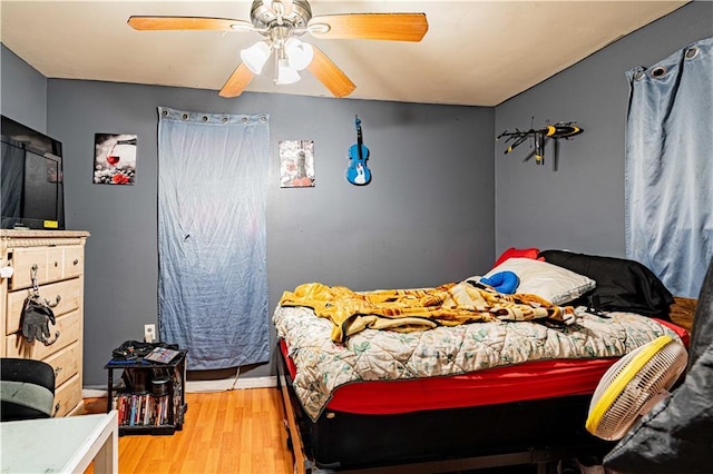 bedroom with ceiling fan and wood finished floors