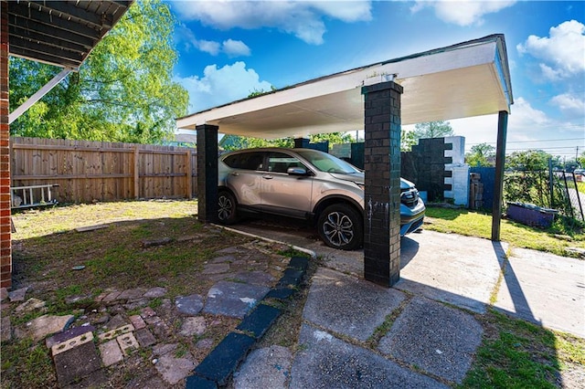 view of parking / parking lot featuring fence