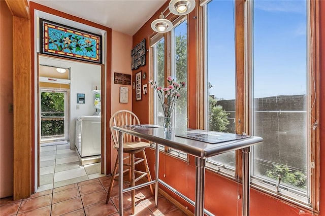 3418 Coliseum St, New Orleans, LA 70115 - bar featuring a wealth of natural light, washer / clothes dryer, and light tile patterned floors