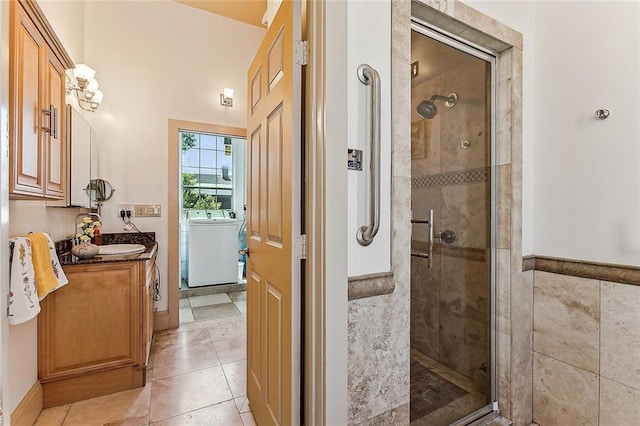 3418 Coliseum St, New Orleans, LA 70115 - full bath featuring tile patterned floors, vanity, washer / clothes dryer, and a stall shower