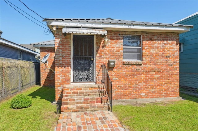 2617 Danneel St, New Orleans, LA 70113 - view of front of property with brick siding, metal roof, and fence