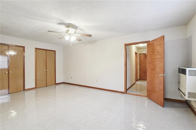 2617 Danneel St, New Orleans, LA 70113 - unfurnished bedroom with baseboards, two closets, a ceiling fan, and light floors