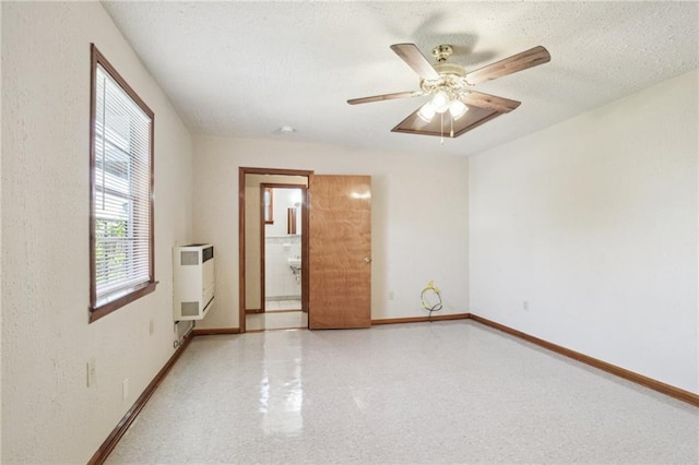 2617 Danneel St, New Orleans, LA 70113 - unfurnished room with baseboards, a ceiling fan, heating unit, and a textured ceiling