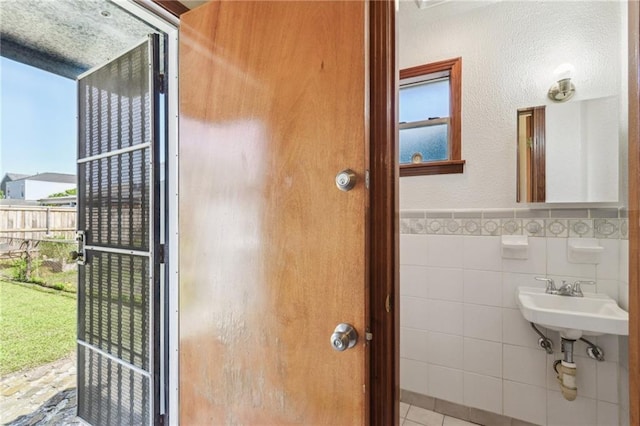 2617 Danneel St, New Orleans, LA 70113 - interior space with a sink, tile walls, and wainscoting