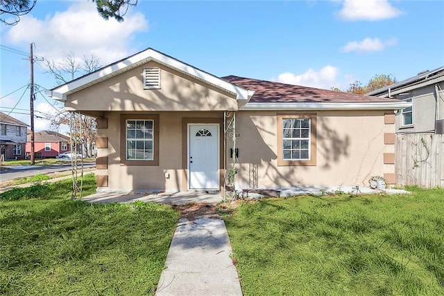 3702 Monroe St, New Orleans, LA 70118 - bungalow-style home with a front lawn, stucco siding, and roof with shingles