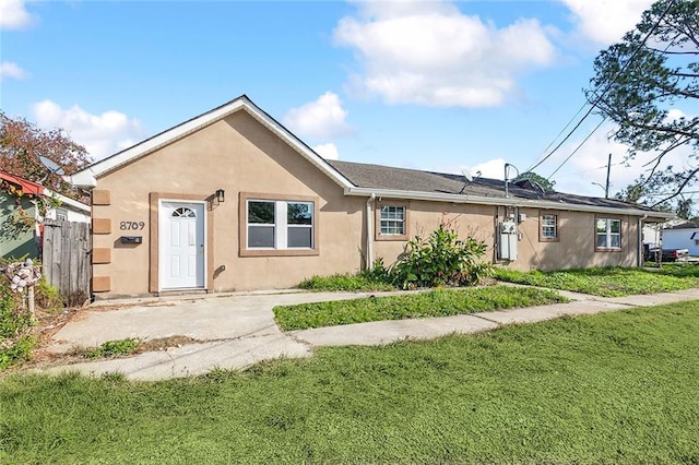 3702 Monroe St, New Orleans, LA 70118 - view of front of home featuring fence, a front lawn, and stucco siding