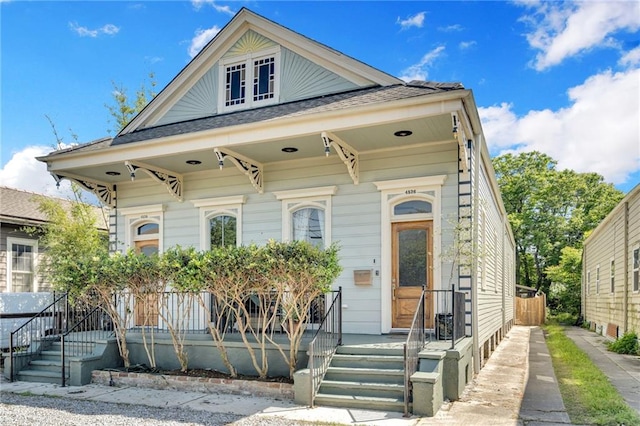 view of front facade featuring a porch and a shingled roof