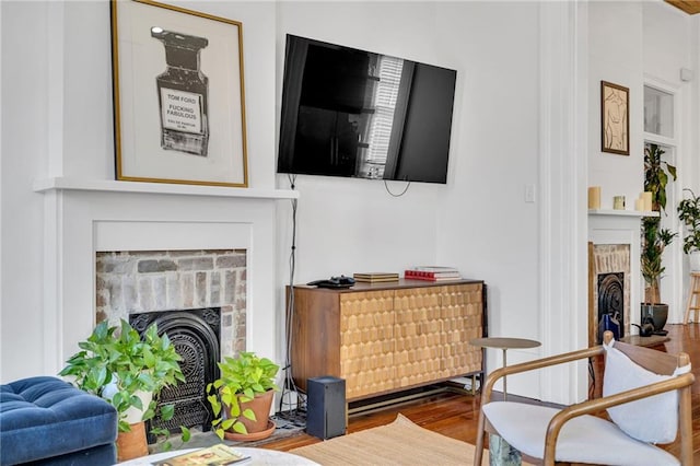 sitting room featuring a fireplace and wood finished floors
