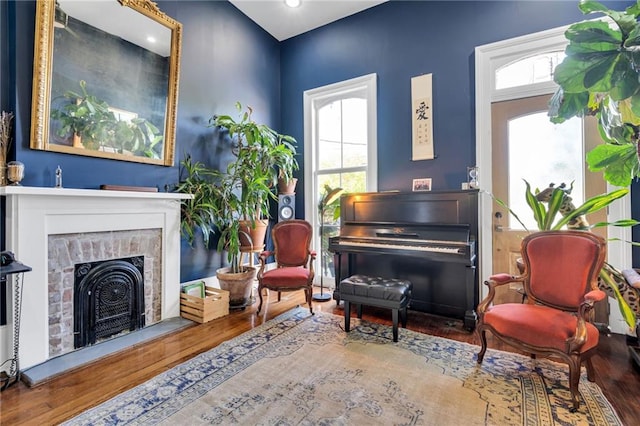 sitting room with wood finished floors, a fireplace, and recessed lighting