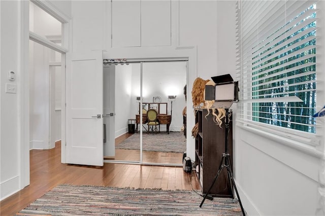 hall with hardwood / wood-style flooring