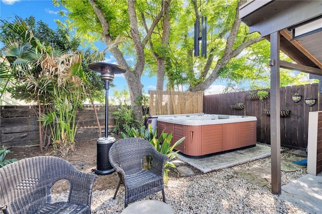 view of yard with a fenced backyard, a patio area, and a hot tub