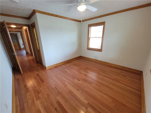 2202 Fazzio Rd, Chalmette, LA 70043 - unfurnished room featuring baseboards, ornamental molding, ceiling fan, light wood finished floors, and attic access