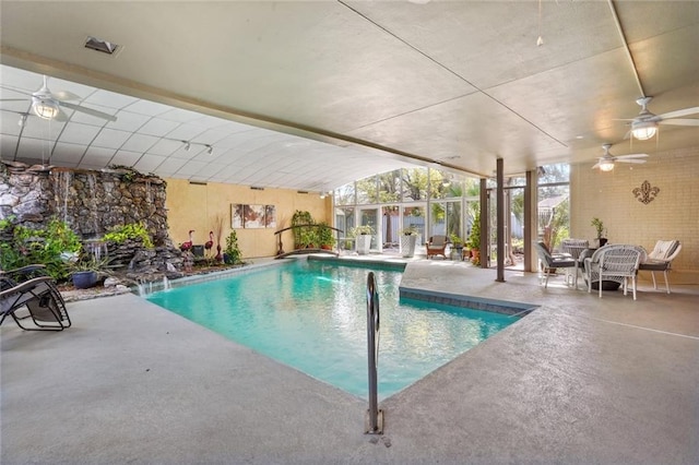 indoor pool featuring a patio area and a ceiling fan